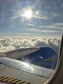 Photo from the plane above the clouds and showing the sun