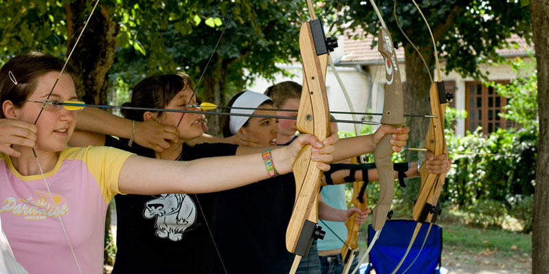 Taking part in an archery lesson.